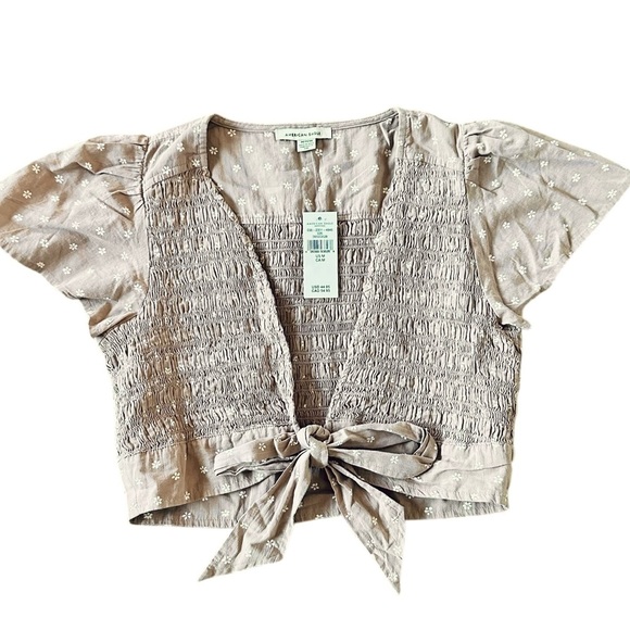 American Eagle Outfitters Tops - AMERICAN EAGLE tan w/white flowers smocked flutter sleeve tie front top M - NWT!
